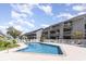 Outdoor swimming pool and patio surrounded by condominium buildings with a blue sky overhead at 206 Maison Dr. # Q-204, Myrtle Beach, SC 29572