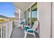 White Adirondack chairs with blue cushions create a cozy balcony seating area with marina views at 2100 Sea Mountain Hwy. # 224, North Myrtle Beach, SC 29582