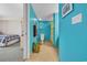 Bright turquoise bathroom with colorful shower curtain and decor complements the nearby bedroom at 2100 Sea Mountain Hwy. # 224, North Myrtle Beach, SC 29582