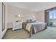 Bright bedroom featuring a king bed, balcony access, and coastal decor at 2100 Sea Mountain Hwy. # 224, North Myrtle Beach, SC 29582