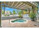 Relaxing hot tub area with a pergola, featuring a brick surround and lush green plantings at 2100 Sea Mountain Hwy. # 224, North Myrtle Beach, SC 29582
