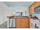 The kitchen with wood cabinets, stainless dishwasher, and breakfast bar at 2100 Sea Mountain Hwy. # 224, North Myrtle Beach, SC 29582