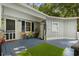 A cozy back porch with seating and a refrigerator, with an artificial turf rug for added comfort at 2128 Adams Circle, Little River, SC 29566