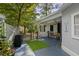 Relaxing covered back porch area with blue painted floor, artificial turf rug, and access to the yard at 2128 Adams Circle, Little River, SC 29566