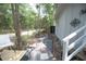 Backyard deck with two chairs, table, and stone pathway at 2128 Adams Circle, Little River, SC 29566