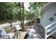 Backyard deck with two chairs, table, and stone pathway at 2128 Adams Circle, Little River, SC 29566