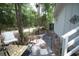 Backyard deck with two chairs, table, and stone pathway at 2128 Adams Circle, Little River, SC 29566
