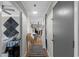 Hallway with hardwood floors and white paneled walls leads to bedroom, living room, and kitchen at 2128 Adams Circle, Little River, SC 29566