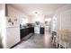 Charming kitchen features black and white cabinets, modern appliances, and cozy dining table at 2128 Adams Circle, Little River, SC 29566