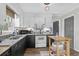 Updated kitchen featuring black countertops, white appliances, and a cozy eat-in area at 2128 Adams Circle, Little River, SC 29566