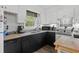 Functional kitchen with a stainless steel sink, black cabinets, and natural light at 2128 Adams Circle, Little River, SC 29566