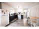 Charming kitchen features black and white cabinets, modern appliances, and cozy dining table at 2128 Adams Circle, Little River, SC 29566