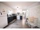 Charming kitchen features black and white cabinets, modern appliances, and cozy dining table at 2128 Adams Circle, Little River, SC 29566