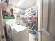 Laundry room with washer, dryer, hot water heater, and storage shelves at 2128 Adams Circle, Little River, SC 29566