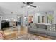 Bright living room with hardwood floors, grey sofa, and view to the kitchen area at 2128 Adams Circle, Little River, SC 29566