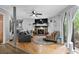 Cozy living room with hardwood floors, a fireplace, and a large sliding glass door to the backyard at 2128 Adams Circle, Little River, SC 29566