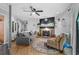 Cozy living room boasts a fireplace with a stylish black mantle, ceiling fan, and comfortable furnishings at 2128 Adams Circle, Little River, SC 29566