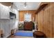 Cozy living room with wood paneling, bright natural light, and decorative furnishings at 2128 Adams Circle, Little River, SC 29566