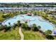 Aerial view of the community pool area with a winding pool, lounge chairs and palm trees at 2151 Bridge View Ct. # 2302, North Myrtle Beach, SC 29582