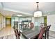 Open-concept dining area with contemporary lighting, seating for six, and an adjacent kitchen at 2151 Bridge View Ct. # 2302, North Myrtle Beach, SC 29582
