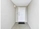 Apartment entrance with neutral colored walls, white door with unit number and a black mat at 2151 Bridge View Ct. # 2302, North Myrtle Beach, SC 29582