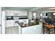 White kitchen featuring modern appliances, granite countertops, and an eat-in bar at 2151 Bridge View Ct. # 2302, North Myrtle Beach, SC 29582