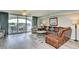 Relaxing living room showcasing a comfortable leather sofa, balcony access, and stylish decor at 2151 Bridge View Ct. # 2302, North Myrtle Beach, SC 29582