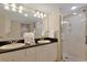 Bright bathroom with double sinks, granite countertops, a large mirror, and stand up shower at 2151 Bridgeview Ct. # 3-405, North Myrtle Beach, SC 29582