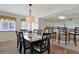 Elegant dining area with a glass-top table, seamlessly connecting to the kitchen area at 2151 Bridgeview Ct. # 3-405, North Myrtle Beach, SC 29582