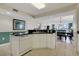 Kitchen with black countertops and white cabinets with an open view of the dining room at 2151 Bridgeview Ct. # 3-405, North Myrtle Beach, SC 29582