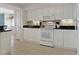 Bright kitchen features white cabinets, modern appliances, and ample counter space at 2151 Bridgeview Ct. # 3-405, North Myrtle Beach, SC 29582