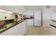 Kitchen with white cabinets, black countertops, modern appliances, and tiled flooring at 2151 Bridgeview Ct. # 3-405, North Myrtle Beach, SC 29582