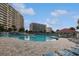 Large outdoor pool area with multiple buildings, lounge chairs, and sunny skies at 2151 Bridgeview Ct. # 3-405, North Myrtle Beach, SC 29582