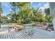 Spacious backyard featuring a built-in bar table with stools, surrounded by lush greenery and pool views at 217 Myrtle Ln., Myrtle Beach, SC 29572