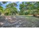 Large, open backyard with mature trees, offering ample space for recreation and outdoor activities at 217 Myrtle Ln., Myrtle Beach, SC 29572