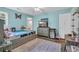 Light filled bedroom with a full bed, dresser, and TV; a mini fridge provides refreshments and comfort at 217 Myrtle Ln., Myrtle Beach, SC 29572