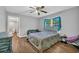 Comfortable bedroom with hardwood floors, neutral walls, fan, and a modern sofa for added relaxation at 217 Myrtle Ln., Myrtle Beach, SC 29572