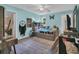 Charming bedroom with blue walls, hardwood floors, ceiling fan, and a cozy daybed and comfortable rug at 217 Myrtle Ln., Myrtle Beach, SC 29572
