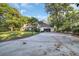 Long driveway leading to a home with an attached garage and basketball hoop for recreation at 217 Myrtle Ln., Myrtle Beach, SC 29572