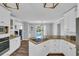 Open-concept kitchen with white cabinets, granite countertops, and modern appliances, perfect for cooking at 217 Myrtle Ln., Myrtle Beach, SC 29572