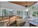 Bright living room boasts wood ceiling, large windows, and a leather sofa, perfect for relaxation at 217 Myrtle Ln., Myrtle Beach, SC 29572