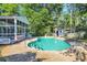 Inviting in-ground pool area with a charming pool house, perfect for outdoor relaxation and entertainment at 217 Myrtle Ln., Myrtle Beach, SC 29572
