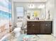 Inviting bathroom with a double vanity, decorative mirror, and beach themed decorations for a relaxed atmosphere at 2217 Belladora Rd., Conway, SC 29527