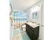 Stylish bathroom with a beach-themed shower curtain, granite vanity, and ample lighting, creating a relaxing atmosphere at 2217 Belladora Rd., Conway, SC 29527