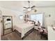 Bright bedroom featuring a modern ceiling fan, large mirror, and a cozy bed, offering a comfortable retreat at 2217 Belladora Rd., Conway, SC 29527