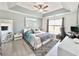 Comfortable bedroom featuring tray ceilings, a ceiling fan, and natural light, creating a serene retreat at 2217 Belladora Rd., Conway, SC 29527