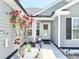 Charming home entrance adorned with colorful flowers and a decorative wreath at 2217 Belladora Rd., Conway, SC 29527