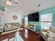 Open living room with hardwood flooring, a teal accent wall, and views of the pool at 2217 Belladora Rd., Conway, SC 29527