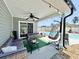 Stylish covered patio with comfortable seating and a view of the pool, perfect for outdoor relaxation at 2217 Belladora Rd., Conway, SC 29527