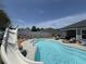 Backyard pool with a slide and lounge chairs, surrounded by a privacy fence at 2217 Belladora Rd., Conway, SC 29527